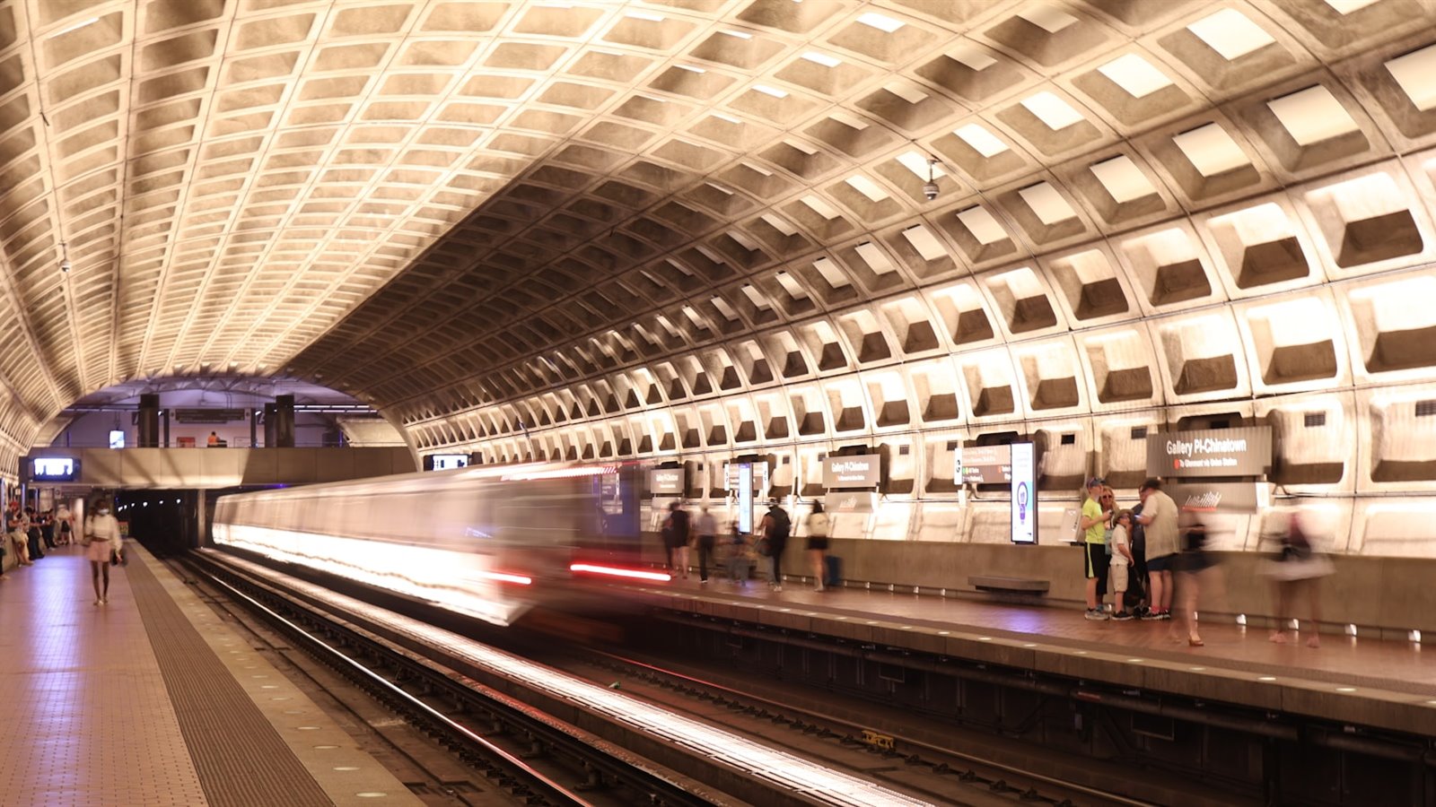 A Washington Metro station platform with a train arriving