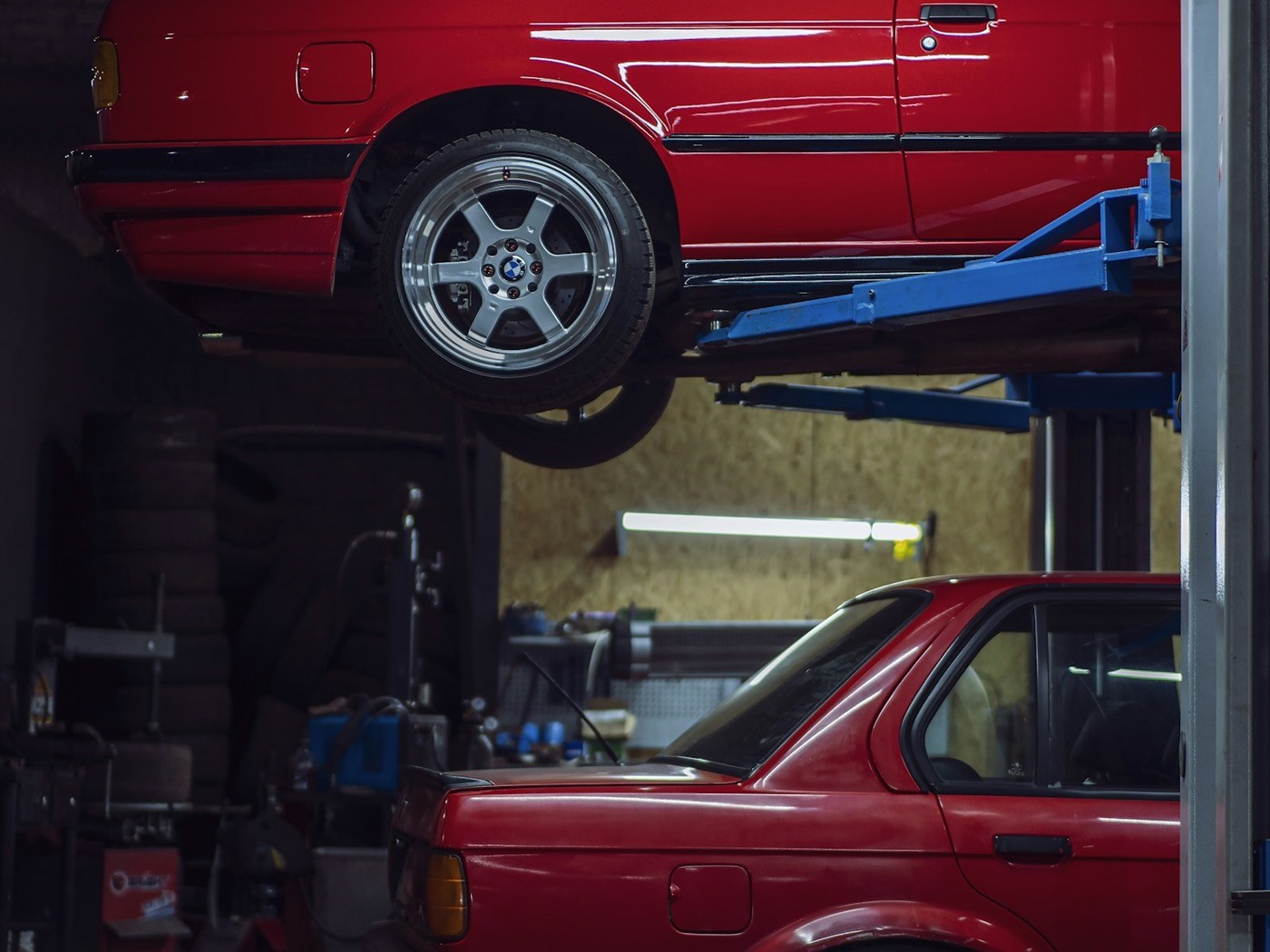 Cars raised on lifts inside an auto repair shop