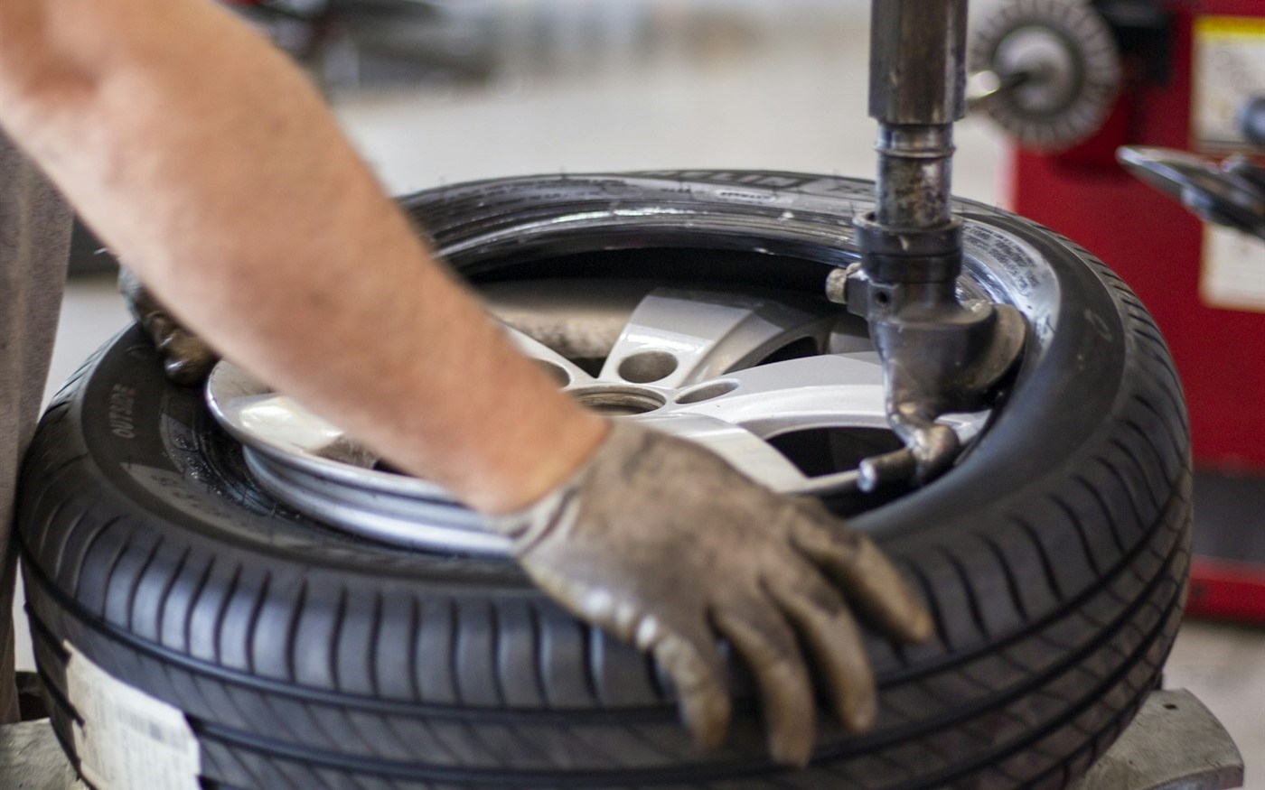 A tire and wheel on a balancing machine
