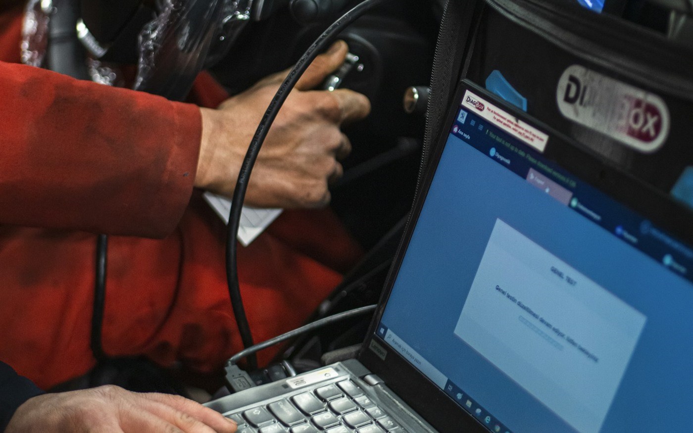 A diagnostic scan tool plugged into a car
