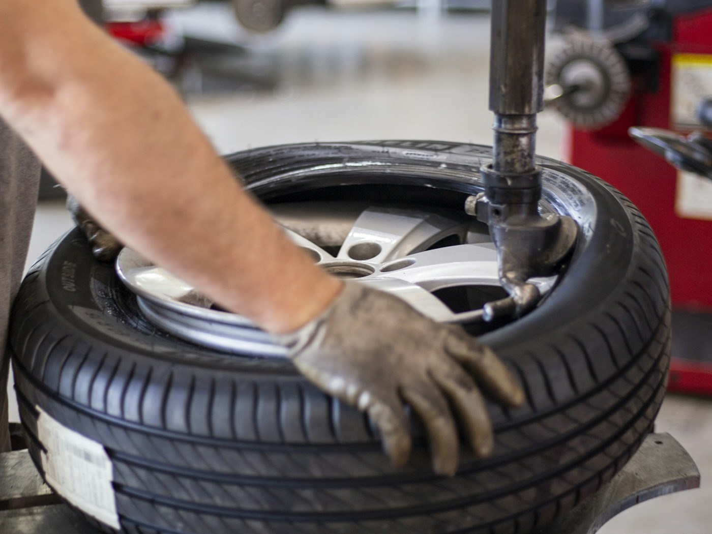A tire and wheel mounted on a balancing machine